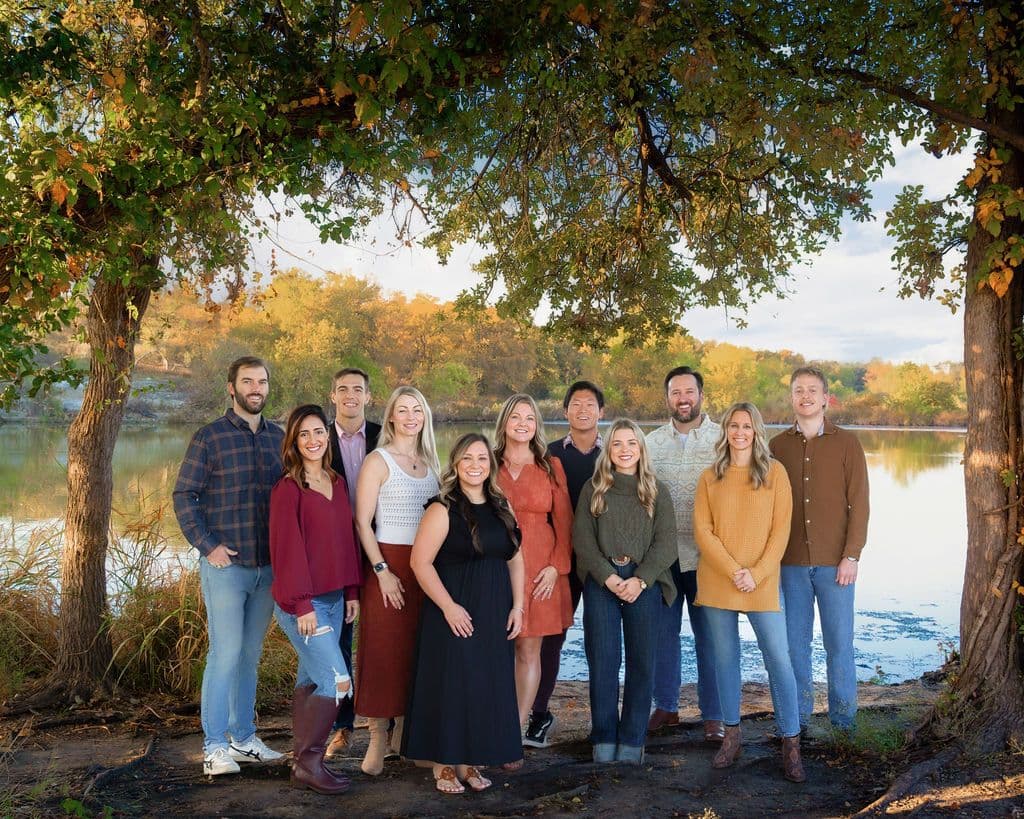The JRE team outdoors by a lake