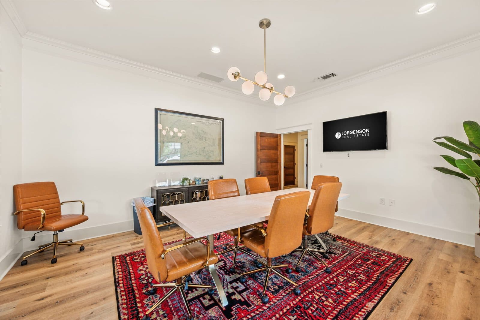 Conference room with leather chairs and a wall screen