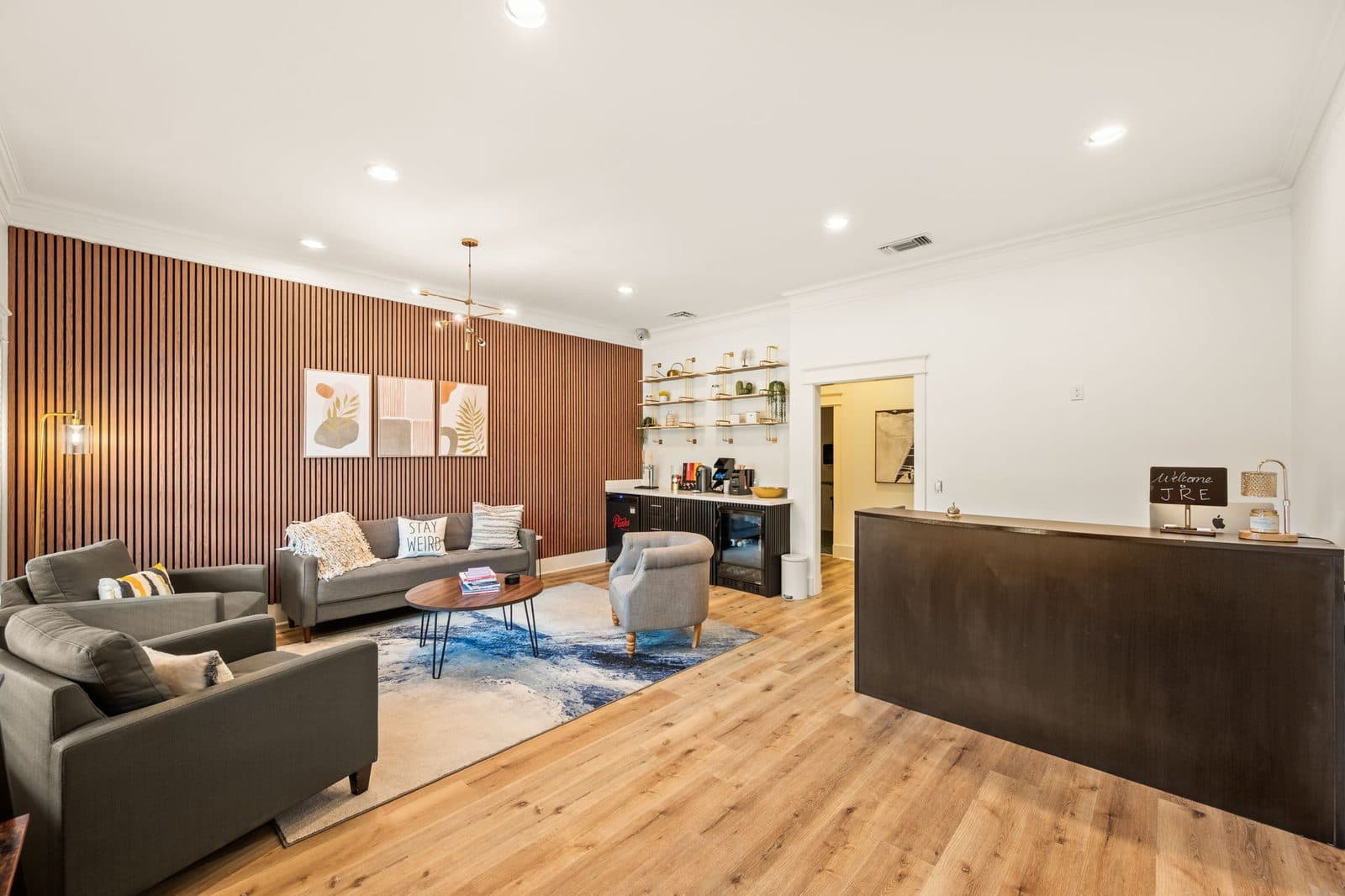 Agent lounge with sofas and a wood slat wall